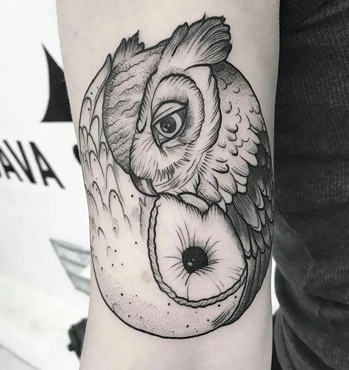 Detailed small bird tattoo with intricate shading on forearm.