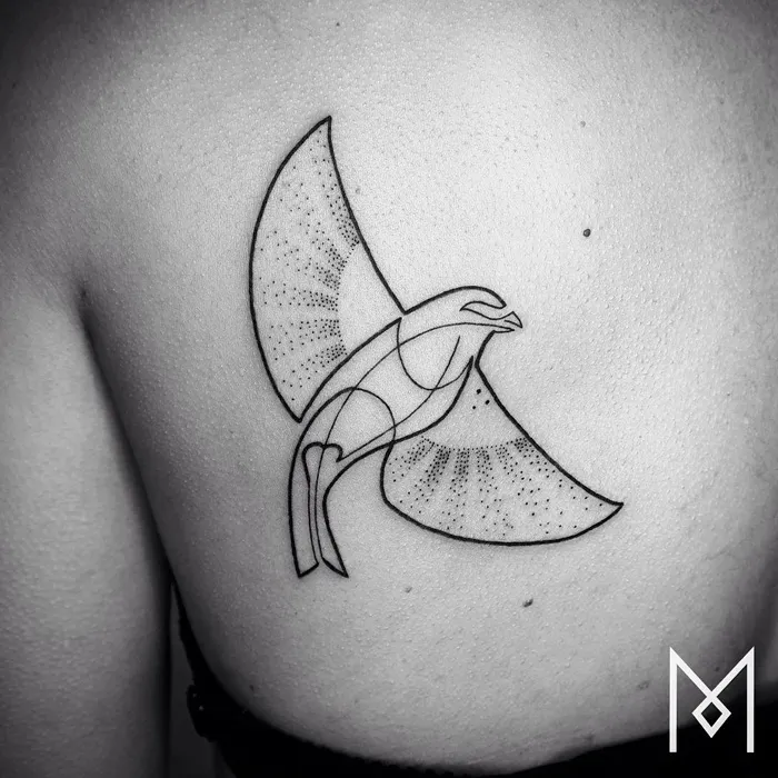 Geometric small bird tattoo design on shoulder, featuring intricate dot patterns and bold lines.