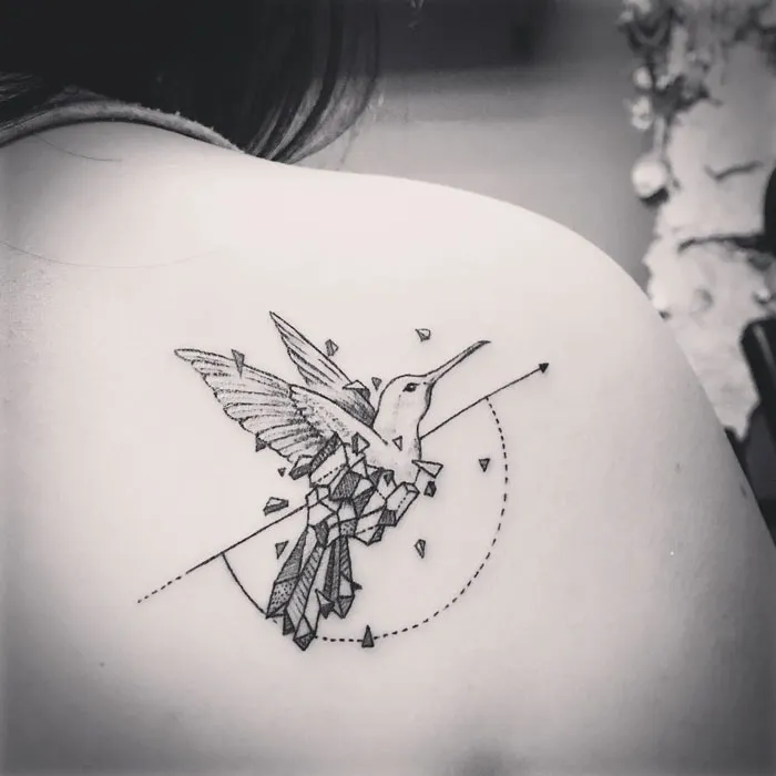 Geometric small bird tattoo on shoulder, featuring intricate details and clean lines, showcasing unique inkspiration.