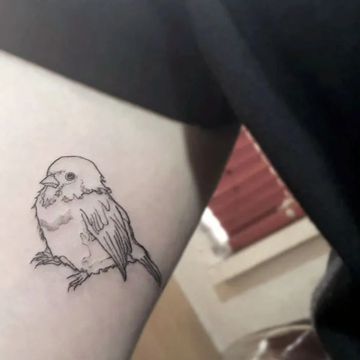 Small bird tattoo on skin, elegant line art design, inspiration for unique bird ink expressions.