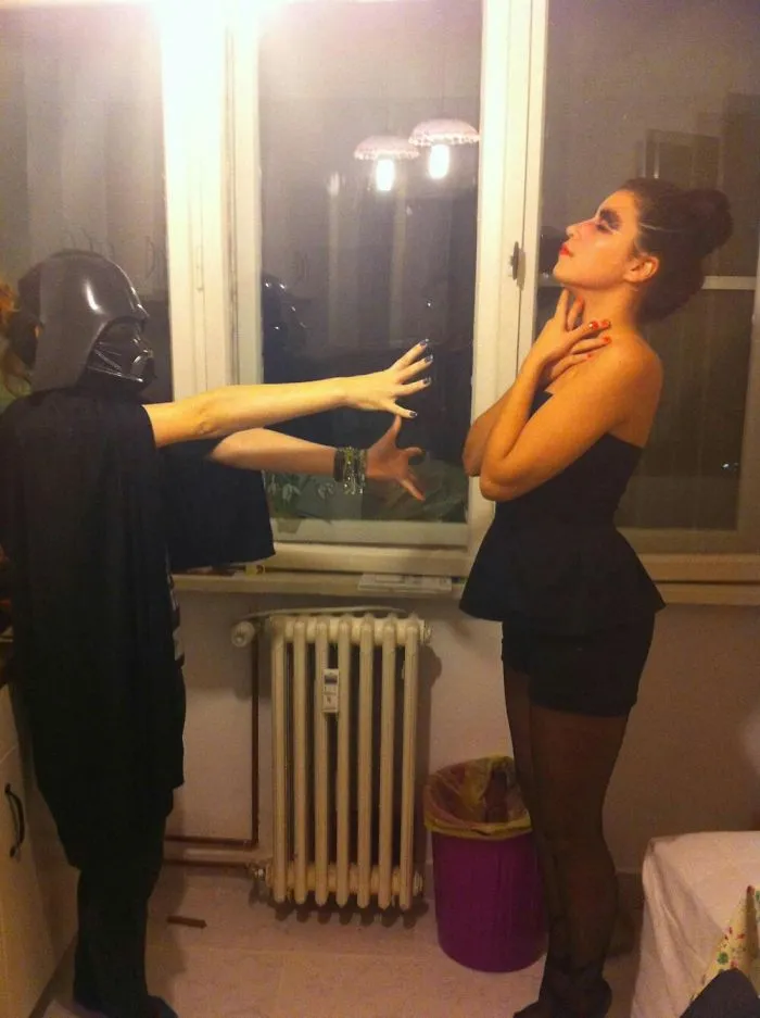 Person in Darth Vader mask pretending to force choke a woman for creative Halloween costume ideas