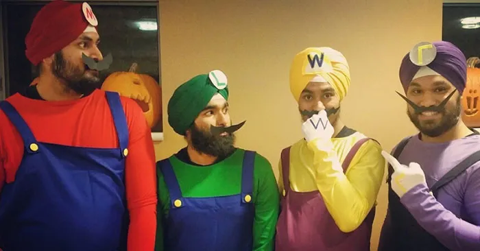 Four men wearing Super Mario Bros group themed turbans and costumes for Halloween costume ideas