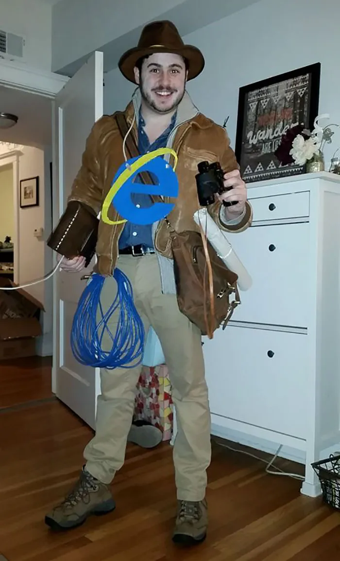 Man dressed as Indiana Jones with Internet Explorer logo, representing funny creative Halloween costume ideas.
