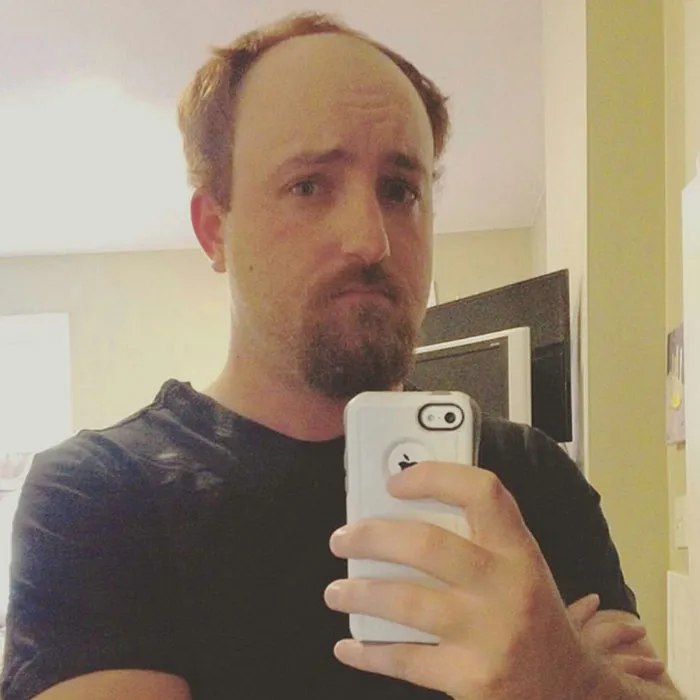 Man taking a selfie dressed as Louis C.K. for creative Halloween costume ideas.