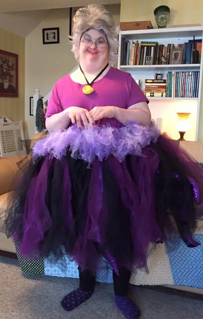 Person dressed as Ursula with a purple tulle skirt and sea witch wig, a creative Halloween costume idea.