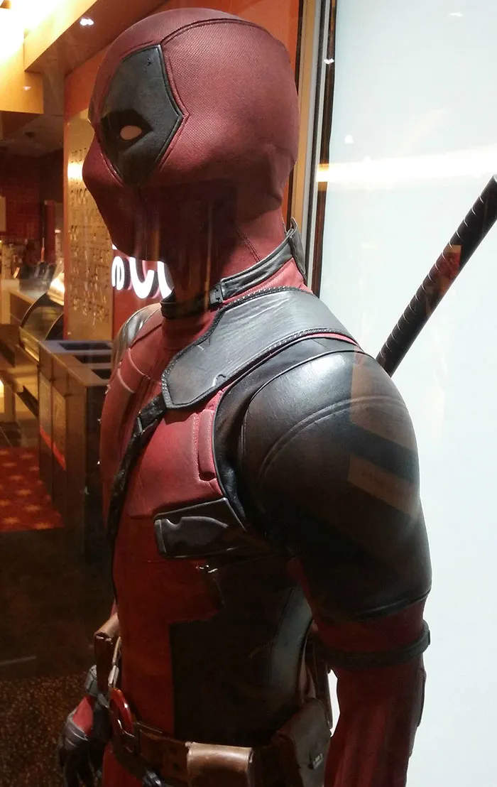 Detailed profile view of a person wearing a realistic Deadpool costume for Halloween.