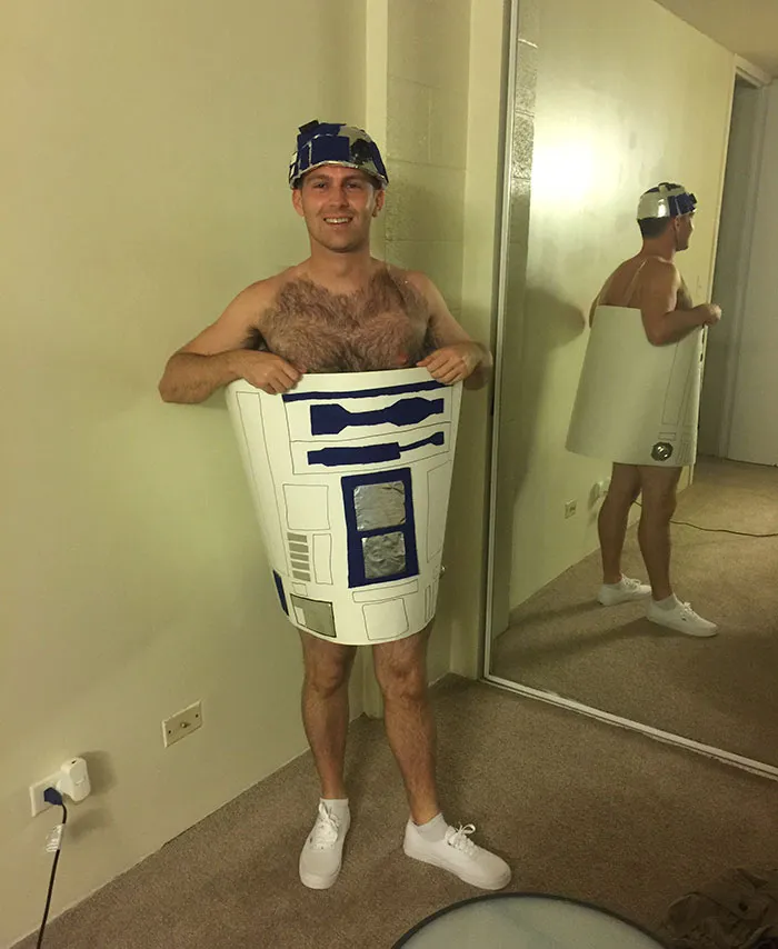 Man wearing a DIY R2-D2 trash can costume as creative Halloween costume ideas