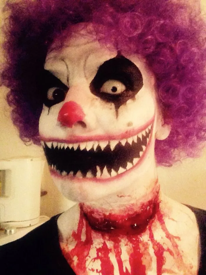 A scary clown face makeup look serving as a creative Halloween costume idea.