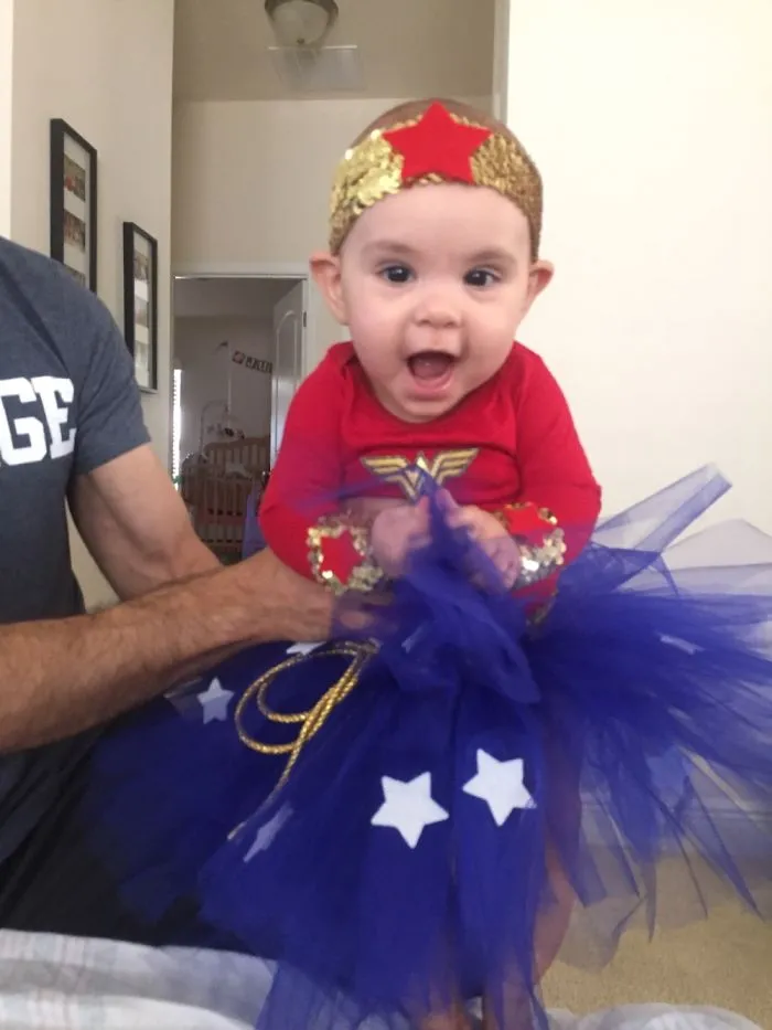 An adorable baby dressed in a Wonder Woman outfit, a cute idea for Halloween costume ideas.