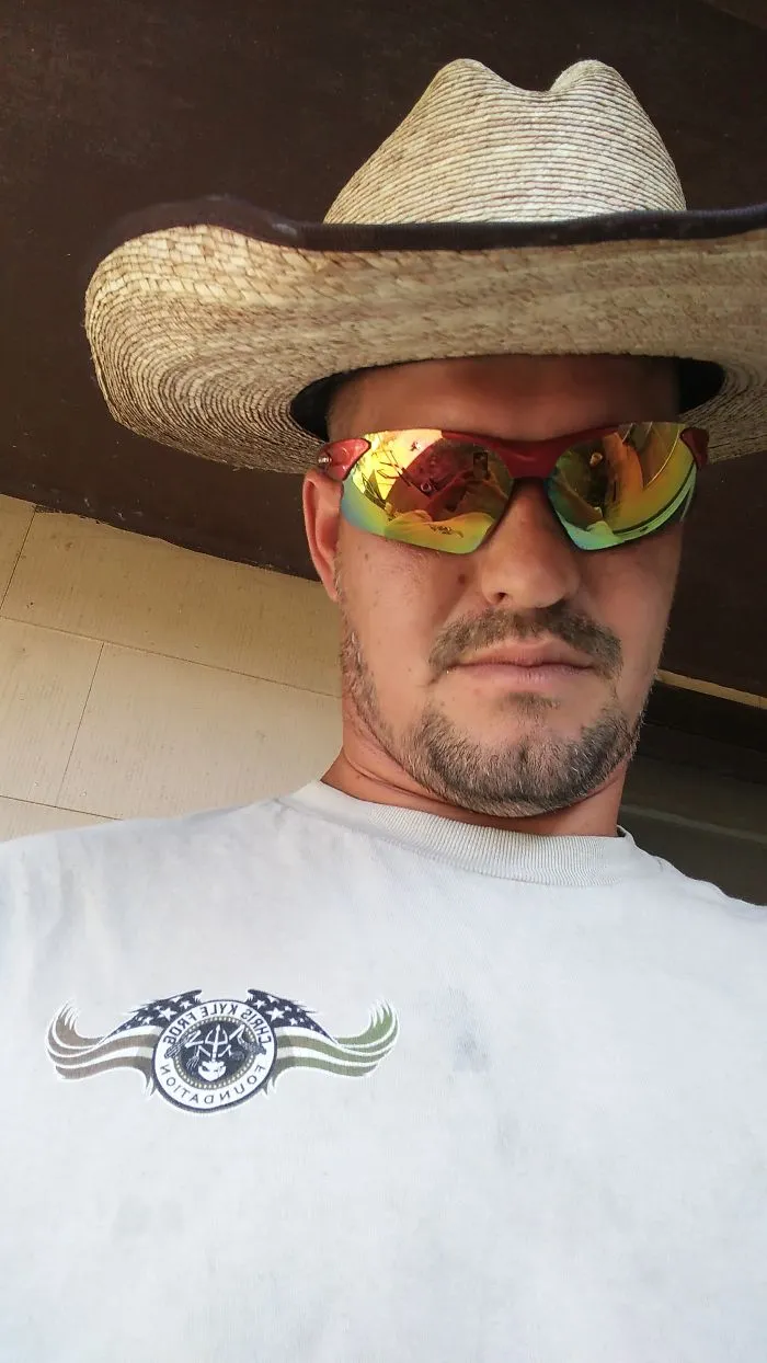 Man wearing reflective sunglasses and a wide-brimmed hat, showcasing changes seen in before and after stopping drinking.