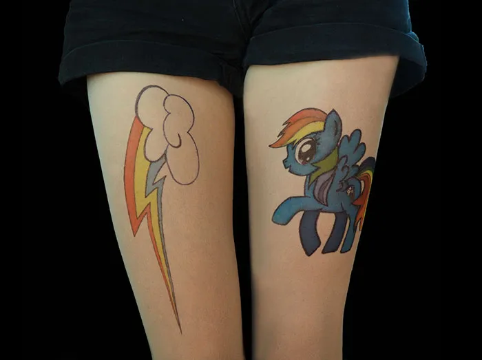Tattoo tights with cartoon designs create an inked illusion on legs wearing shorts.