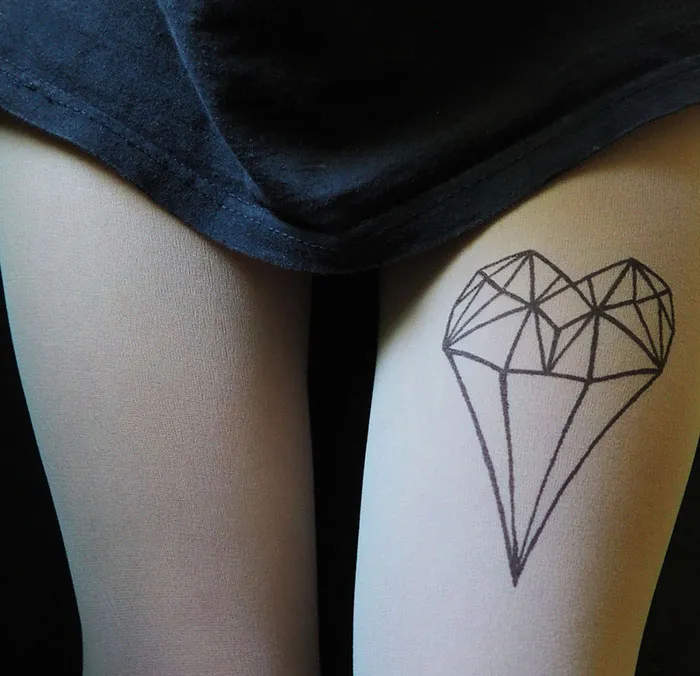 Tattoo tights with geometric heart design creating an inked illusion on legs.