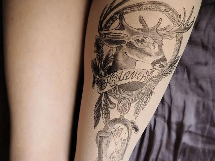Tattoo tights creating an illusion of an inked deer design on a leg.