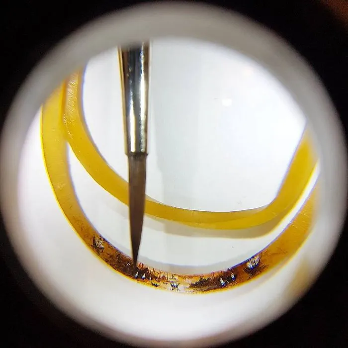 Turkish Artist Paints Unbelievably Tiny Paintings Onto Small Objects