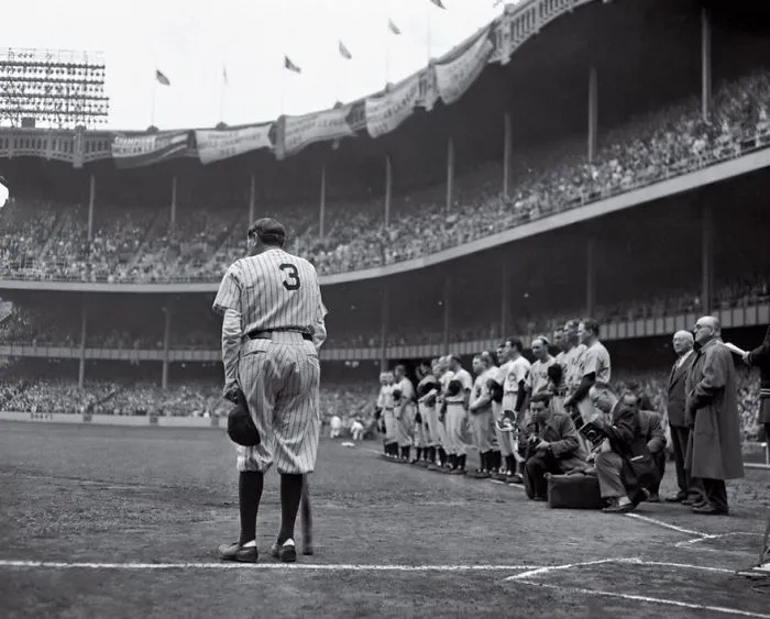 Baseball legend in uniform with number 3, standing on a crowded field during a historic game, symbolizing famous photos in history.