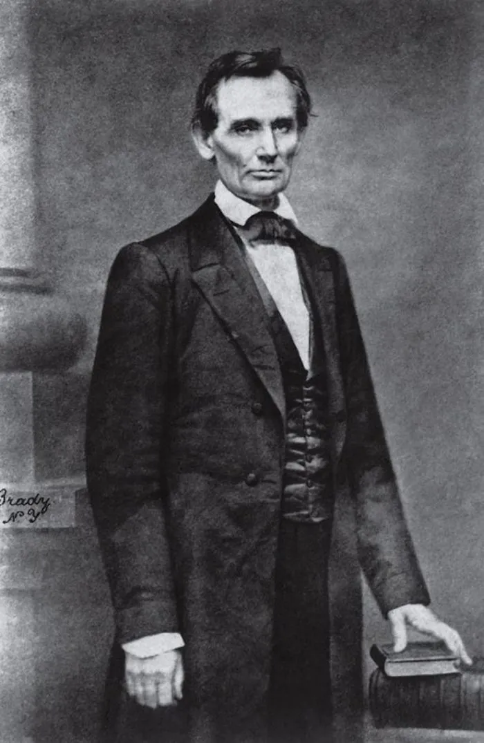 Historic black-and-white portrait of a man in formal attire, holding a book, exemplifying famous historical photos.