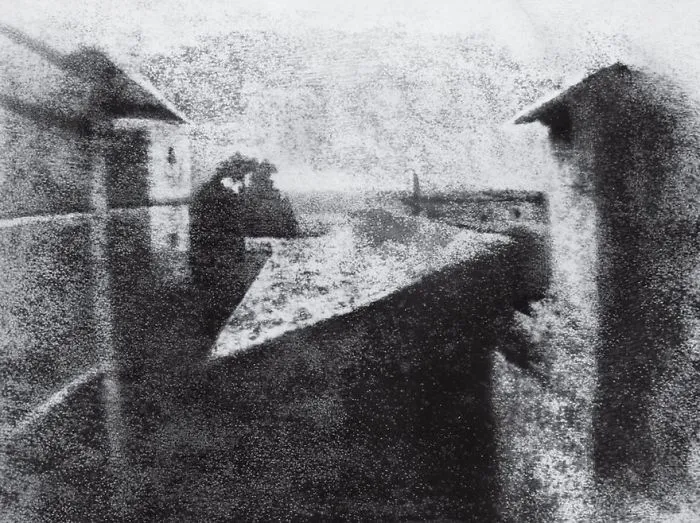 Historic photo of rooftops and a distant horizon in black and white, capturing a seminal moment in photography history.