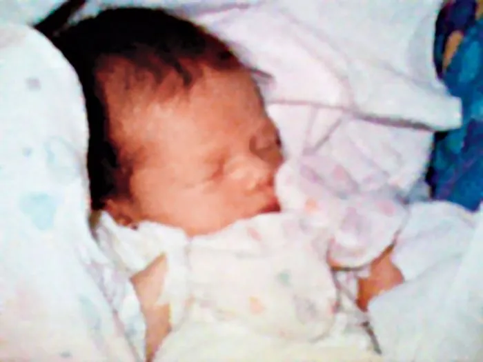 Newborn baby sleeping peacefully wrapped in blankets; historical famous photo.