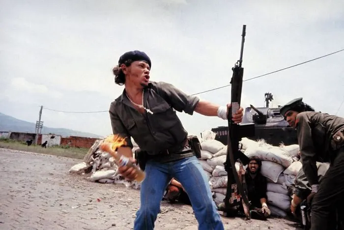 Revolutionary holding a Molotov cocktail in a historic protest, symbolizing defiance and change, famous photos in history.