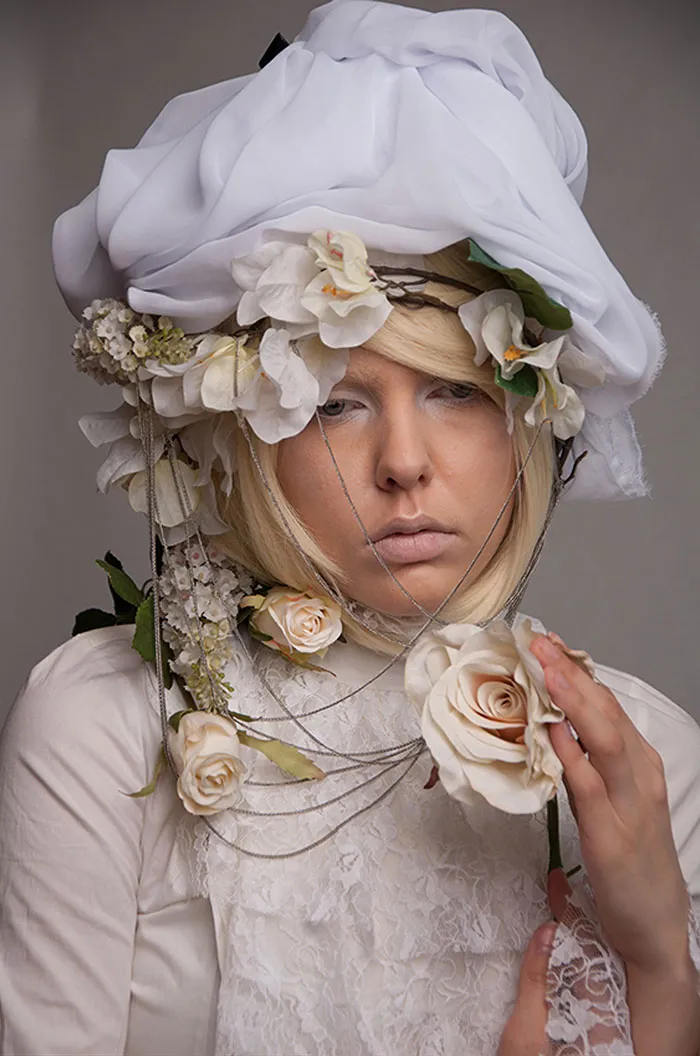 Person in floral headpiece and lace attire, showcasing photo retouching techniques for beautiful photos transformation.