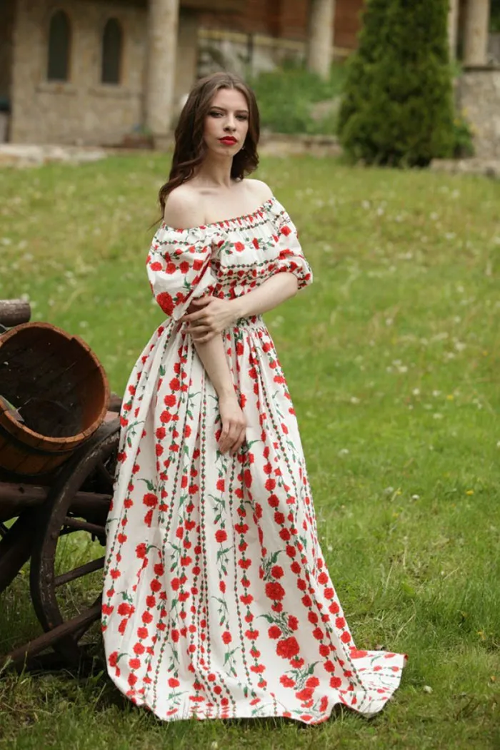 Woman in a floral dress standing in a garden, showcasing beautiful photos before Photoshop.