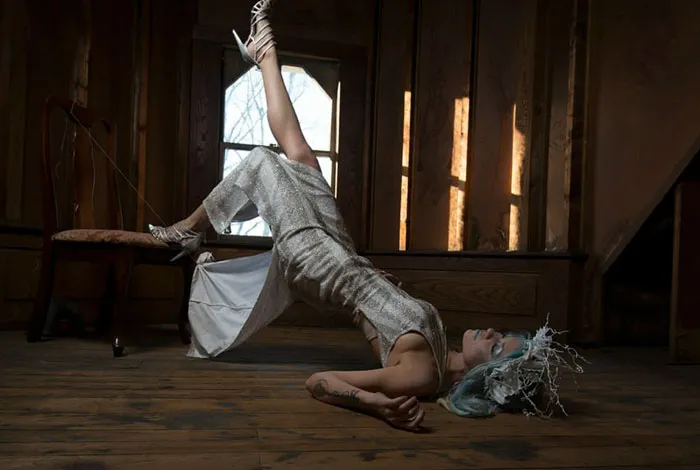 Woman posing creatively in an artistic setting, showcasing the transformative effect of Photoshop behind beautiful photos.
