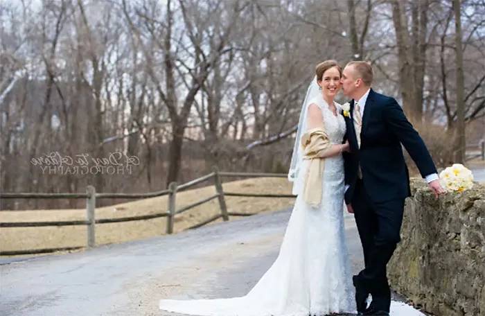 Wedding couple posing outdoors on a winter day before Photoshop enhancement, showcasing the truth behind beautiful photos.