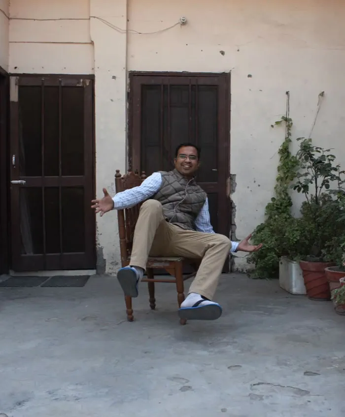 Man in casual attire poses outdoors before Photoshop editing, highlighting the truth behind beautiful photos.