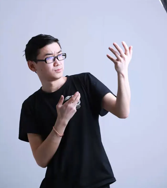 Man in a black shirt posing humorously, demonstrating before and after Photoshop effects in photography.