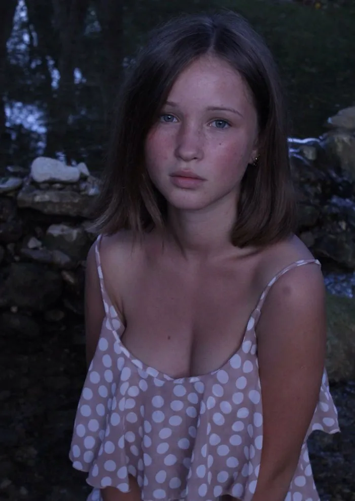 A young woman in natural lighting, showcasing the truth behind beautiful photos before Photoshop.