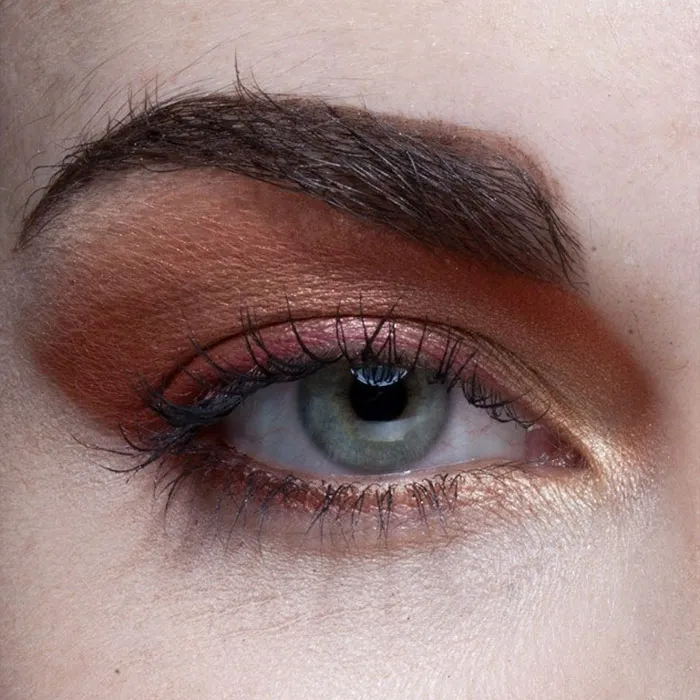 Close-up of a woman's eye with makeup, illustrating the truth behind beautiful photos before Photoshop.