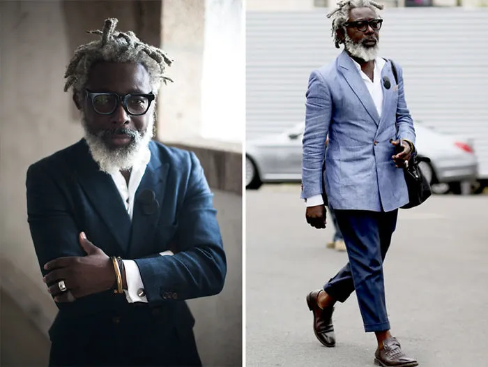 Stylish older man with glasses in a blue suit, exuding confidence and redefining the concept of older men.