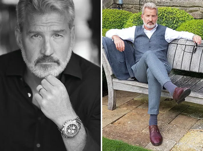 Stylish older man with silver hair, wearing a vest and sitting on a bench, redefining handsome mature looks.
