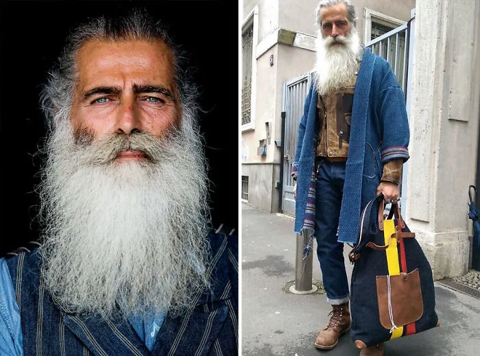 Stylish older man with a long white beard wearing a denim jacket and holding a colorful bag, redefining handsome style.