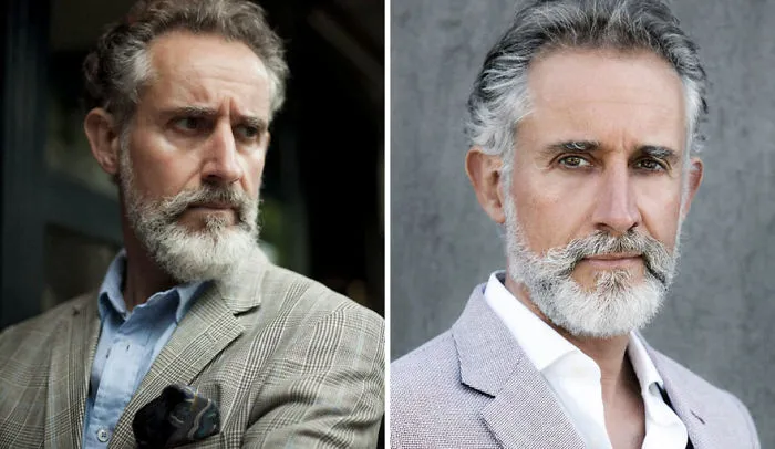 Older man with a stylish gray beard in a plaid blazer and blue shirt, showcasing handsome elegance.