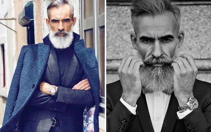 Stylish older man with a beard, wearing a suit and coat, showcasing modern fashion for older men.