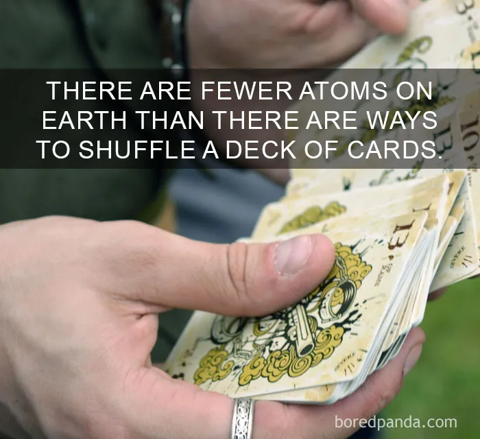 Person shuffling old playing cards illustrating amazing facts that change the way you see the world concept.