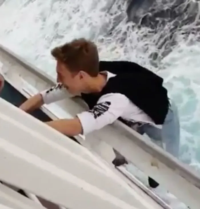 Daredevil Teenager Risks His Life By Hanging Off The Edge Of A Cruise Ship