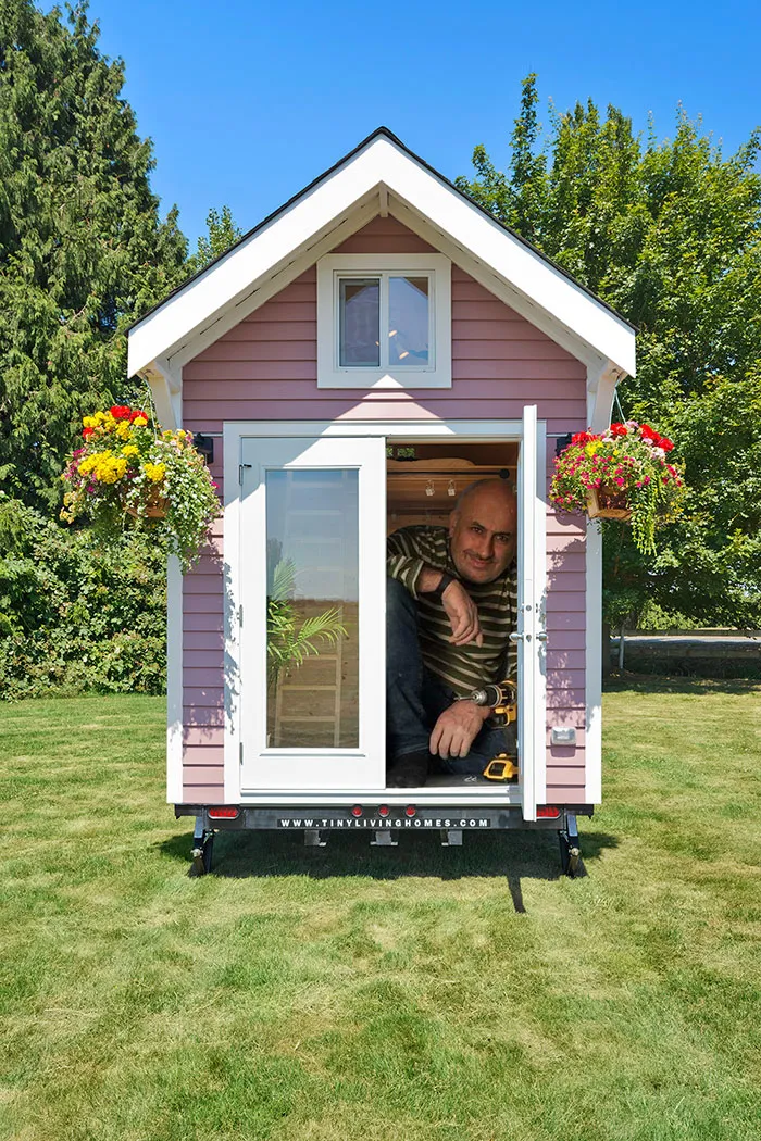 Normal Sized Man In A Really Tiny Tiny House Or Giant Sized Man In A Regular Tiny House. You Decide