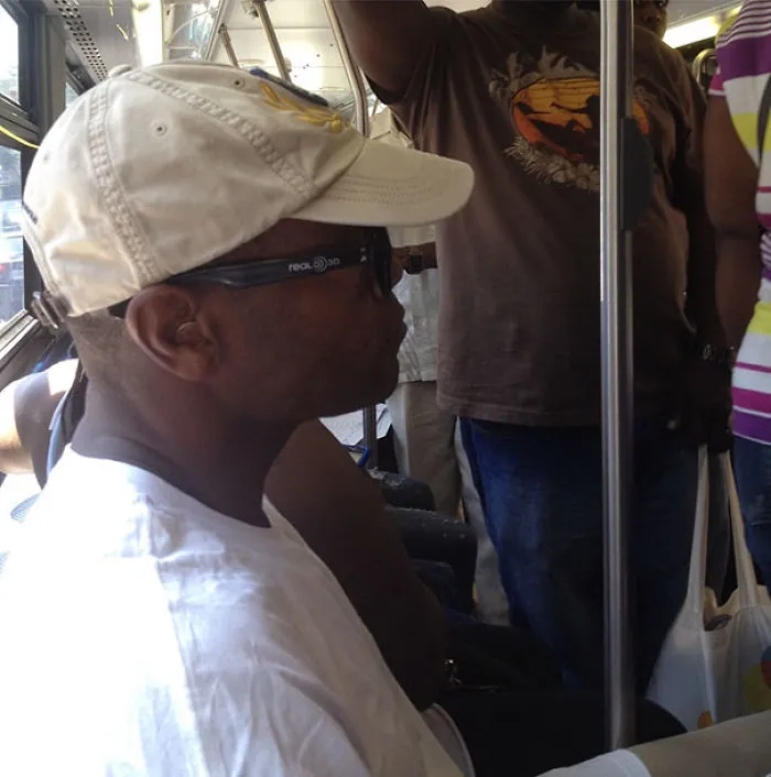 Man wearing 3D glasses on bus, creating an unexpected "when you see it" illusion.