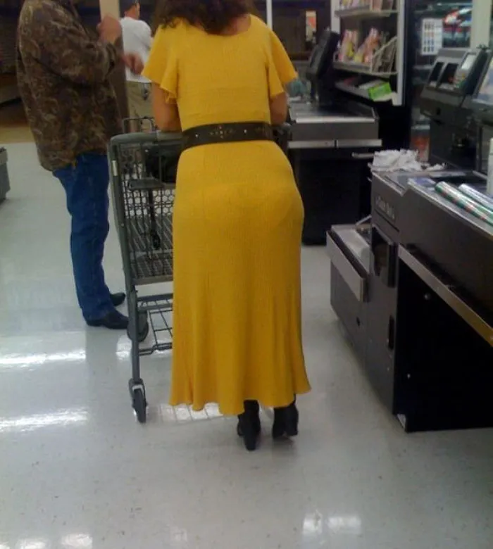 Woman in yellow dress at checkout, creating an unexpected optical illusion.