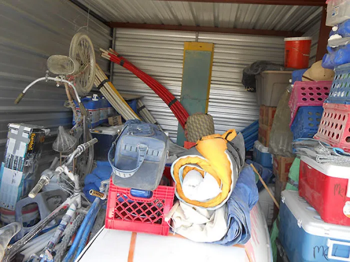 Cluttered storage unit filled with various items, with a hidden surprise to notice upon a closer look.