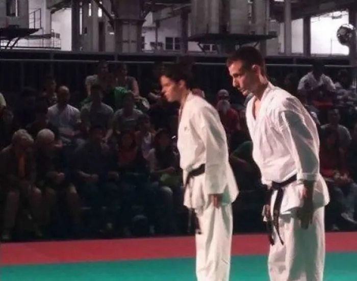 Martial artists bowing at a tournament with an unexpected detail in the crowd that will freak you out when you see it.