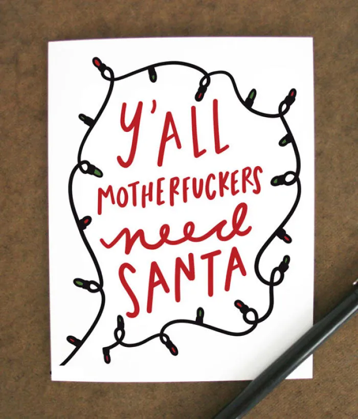 Rude Christmas card with a humorous message surrounded by festive lights.