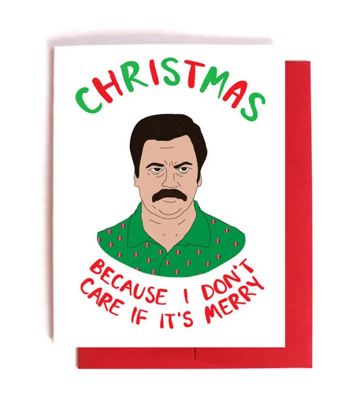 Rude Christmas card with a grumpy man illustration and text, "Because I don't care if it's merry," in festive colors.