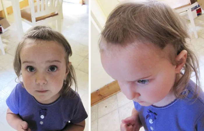 Child with a self-given haircut, looking up, wearing a purple shirt, exemplifying regretful kids' haircuts.