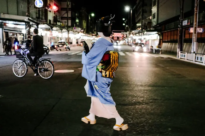 Maiko Crossing Road In Kyoto