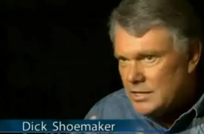 A man named Dick Shoemaker, a humorous name, in an interview setting with a serious expression.