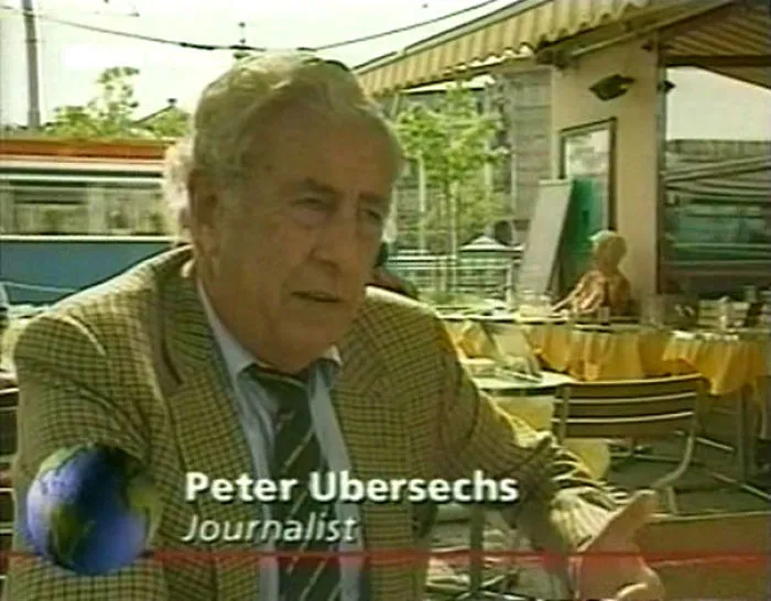 A journalist named Peter Ubersechs at an outdoor café, discussing funny names in an interview setting.