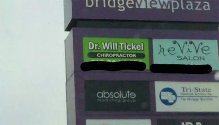 Sign for chiropractor Dr. Will Tickel, showcasing a funny name, at a shopping plaza directory.